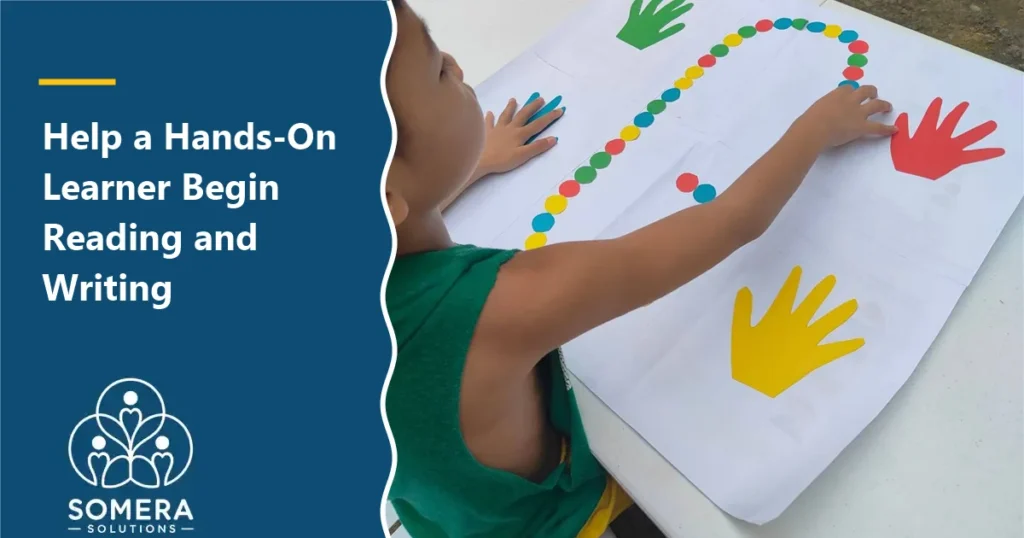 Child reaching across a large paper to trace a path of colored dots between colored paper hands.